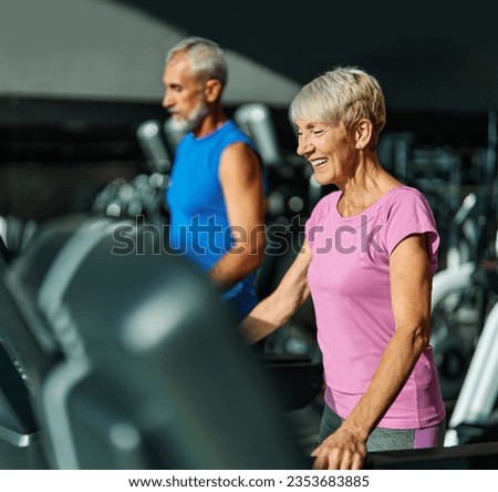 Portrait of a senior woman exercising in a gym, mature couple running using treadmill machine equipment, healthy lifestyle and cardio exercise at fitness club concepts, vitality and active senior, 