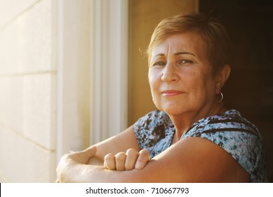 Portrait of senior woman looking from the balcony