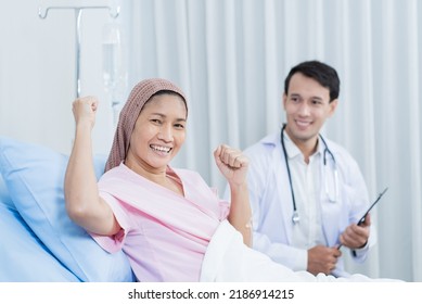 Portrait Of Senior Woman Patient Lying Down With Doctor In Hospital Ward. Physician Therapist Pharmacist Man Visit And Give Diagnosis Service Treatment Elderly Older Female And Smile, Look At Camera.