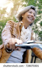 Portrait Of Senior Woman Riding City Bike