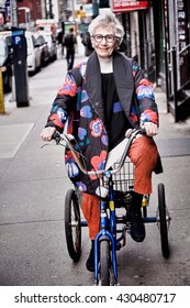 Portrait Of Senior Woman Riding Tricycle