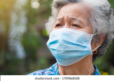 Portrait of senior woman with short white hair, wearing face mask for health because have air pollution PM 2.5. Mask for protect virus, bacteria, pollen grains. Health care concept - Powered by Shutterstock