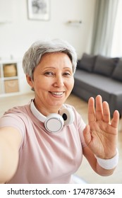 Portrait Of Senior Woman Smiling At Camera And Waving Her Hand She Say Hello