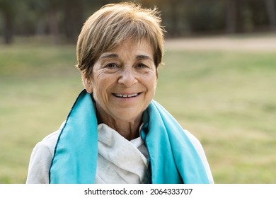 Portrait Of Senior Woman Smiling On Camera After Workout Sport Session Outdoor At City Park - Focus On Face