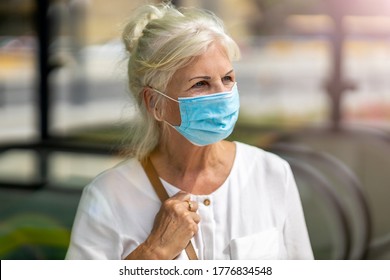 Portrait of senior woman wearing protective face mask outdoors in city - Powered by Shutterstock