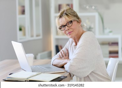 Portrait of senior woman working on laptop computer