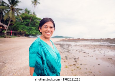 Portrait Of Senior Woman.Senior Adult Women Smiling Happy On The Sea Summer Beach Freedom.indian Mother Woman.60 Years Old Women.Grandmother Grandparent.Kind Face Looking Camera.mental Health Day.