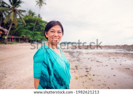 Portrait of senior woman.Senior Adult Women Smiling Happy on the sea summer beach freedom.indian mother woman.60 years old women.Grandmother grandparent.Kind face looking camera.mental health day.