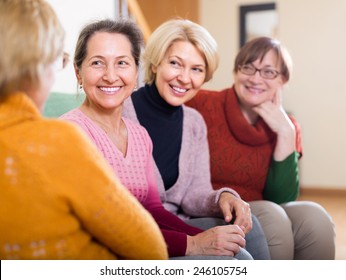 Portrait Of Senior Women Having Discussion Indoor And Laughing. Focus On One