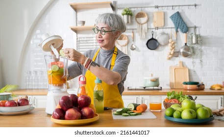 Portrait seniors Asian woman preparing to make fruit and vegetable juice in the kitchen. - Powered by Shutterstock