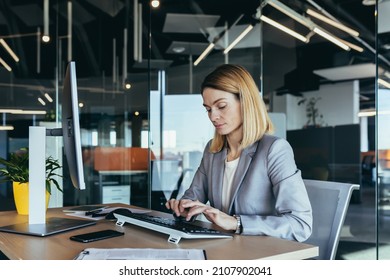 Portrait Of A Sensible And Fair Successful Woman, Businesswoman Working In A Modern Office, At The Computer, Confident And Focused