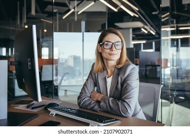 Portrait Of A Sensible And Fair Successful Woman, Businesswoman Working In A Modern Office, At The Computer, Confident And Focused