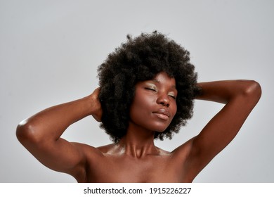 Portrait Of Sensual African American Female Model With Afro Hair And Perfect Glowing Skin Posing With Eyes Closed Isolated Over Gray Background. Skin Care, Diversity Concept