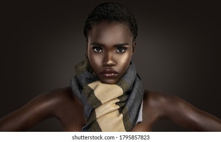 A Portrait Of A Sensual Young Female With Short Black Hair, Beautiful Makeup And Moist Lips Wearing A Colorful Scarf In Front Of A Dark Background.