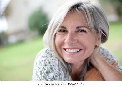 Portrait of serene mature woman in garden - Shutterstock ID 155611865