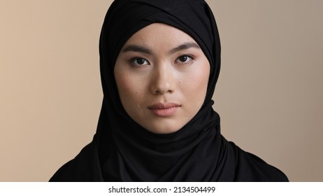 Portrait Serious Asian Korean Malaysian Girl In Black Hijab Traditional Headscarf Lonely Muslim Woman Alone Islamic Female Sad Upset Lady Looking At Camera Indoors Religious Discrimination Concept