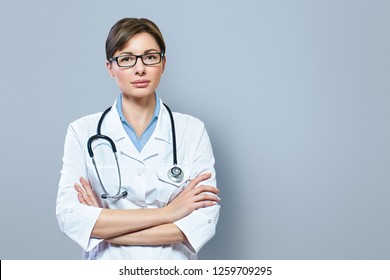 Portrait Of Serious Doctor With Stethoscope Looking At Camera.Medical Physician Doctor Woman Over Blue Clinic Background