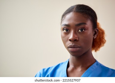 Portrait Of Serious Female Nurse Or Doctor Wearing Scrubs