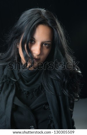 Portrait serious gypsy woman over black background
