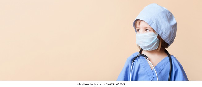 Portrait Of Serious Little Girl Dressed Up In Doctor Holds On Hands Baby Doll On Isolated Background /concept  Pediatric Emergency/obstetrics/abortion Protest/artificial Insemination