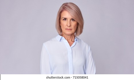 Portrait Of Serious Old Business Woman Looking At Camera. Isolated On Grey