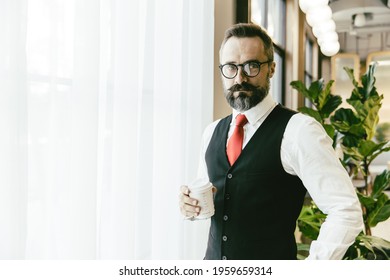 Portrait Serious Professional Conservative Adult Model Businessman Latin Beard Standing Hand Holding Coffee Cup In Modern Office With Copy Space For Text.