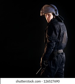 Portrait Of A Serious Riot Policeman Isolated On Black