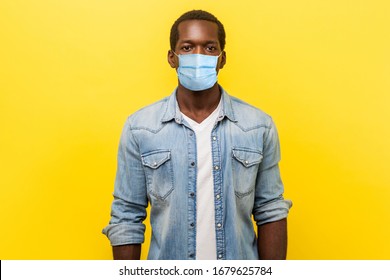 Portrait of serious self-assertive handsome man with medical mask with rolled up sleeves looking smart and professional, freelancer or employee. indoor studio shot isolated on yellow background - Powered by Shutterstock