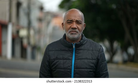 Portrait Of A Serious Senior Black Man Standing Outside In Street Looking At Camera