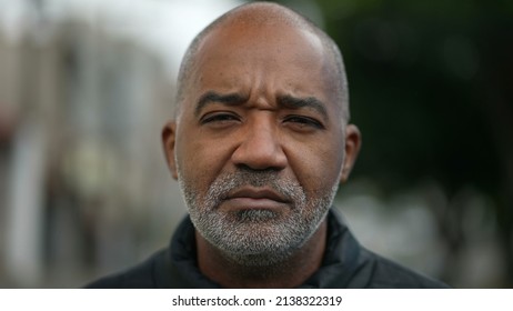 Portrait Of A Serious Senior Black Man Standing Outside In Street Looking At Camera