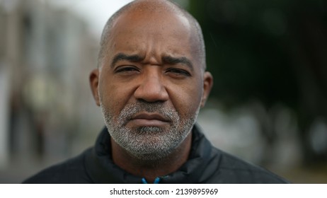 Portrait Of A Serious Senior Black Man Standing Outside In Street Looking At Camera