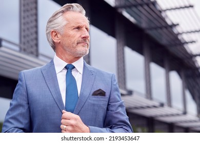 Portrait Of Serious Senior Businessman CEO Chairman Standing Outside Modern Office Building