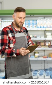 Portrait Of Serious Supermarket Clerk Using App On Digital Tablet, Grocery Store Worker Ordering Goods Online, Retail Concept