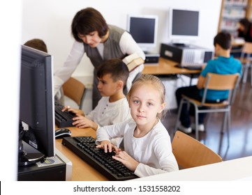 Portrait Of Serious Tween Girl During Lesson In Computer Room Of School Library 