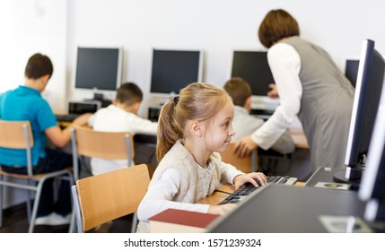 Portrait Of Serious Tween Girl During Lesson In Computer Room Of School Library 