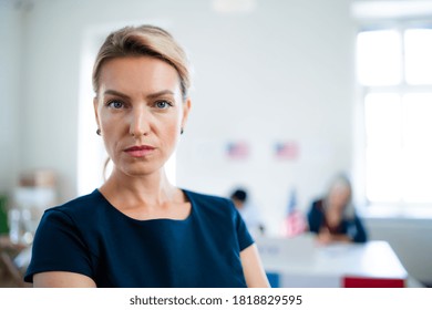 Portrait Of Serious Woman In Polling Place, Usa Elections Concept.