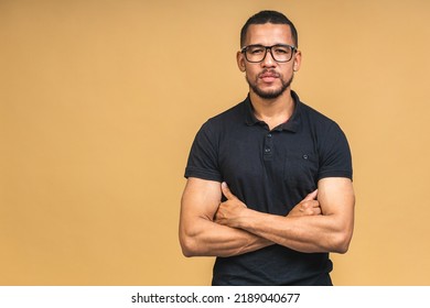 Portrait Of A Serious Young African American Black Business Man Standing Isolated Over Beige Background.
