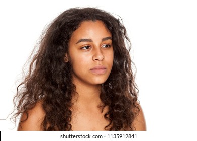 portrait of a serious young dark-skinned woman without makeup on a white background