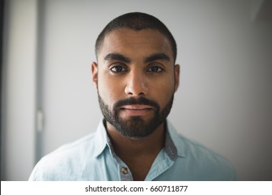 Portrait Of Serious Young Man Against Wall