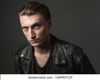 Portrait of the serious young man in leather jacket