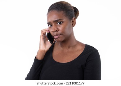 Portrait Of Serious Young Woman Talking On Mobile Phone. African American Lady Wearing Black Long Sleeve Calling Friend Against White Background. Mobile Technology Concept