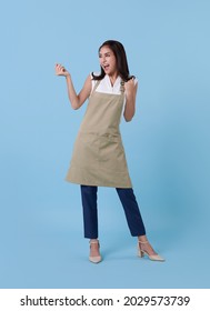 Portrait of service minded asian woman employee studio shot on blue background - Shutterstock ID 2029573739