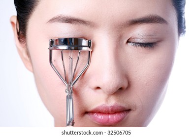 Portrait Of Sexy Asian Young Woman Holding Eye Lash Curler