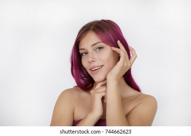 Portrait of a sexy beautiful woman with her flowing purple hair and kind eyes touching her face and neck on a white background. People, youth, leisure and lifestyle concept.
 - Shutterstock ID 744662623