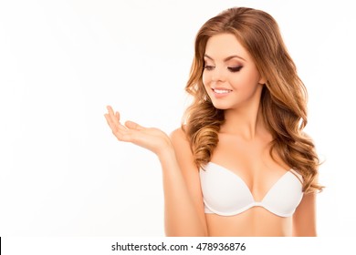 Portrait of sexy happy woman in white bra showing her wrist