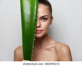 Portrait Of Sexy Woman With Green Aloe Leaf Bare Shoulders Clear Skin 