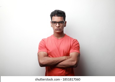 Portrait of a sharp looking young man of Indian origin with folded hands