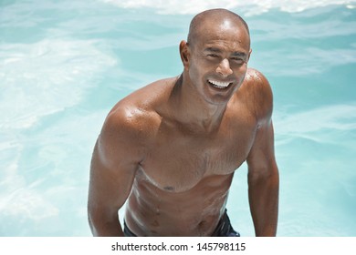 Portrait Of Shirtless African American Man In Swimming Pool Smiling