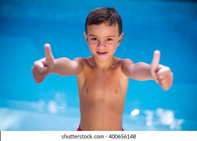 Portrait Of Shirtless Boy Gesturing At Swimming Pool