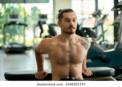 Portrait of shirtless caucasian handsome and muscular sport fitness man with perfect abs and bicep muscle warm up  in sport gym. - Powered by Shutterstock